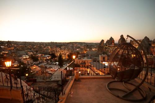a view of a city from a balcony at night at Asteria Cave Hotel in Goreme
