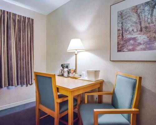 a hotel room with a table and two chairs at Rodeway Inn Saint John in Saint John