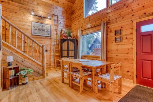 a dining room with a table and chairs and a red door at Blue Pine Chalet in Government Camp