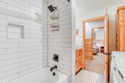 a white bathroom with a tub and a sink at Blue Pine Chalet in Government Camp