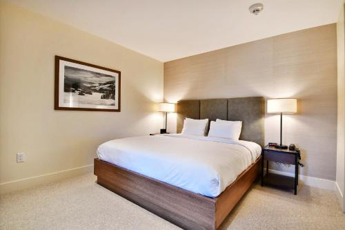 a bedroom with a large bed and two lamps at Lift Park City Condominiums in Park City