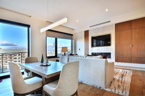 a dining room and living room with a table and chairs at Lift Park City Condominiums in Park City