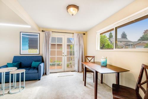 a living room with a blue couch and a table at City Brilliance in University Place
