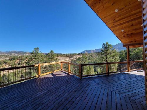 a wooden deck with a view of the mountains at Cliff's Edge. New Build, Breathtaking Views, Luxury Stay Near Zion in Orderville