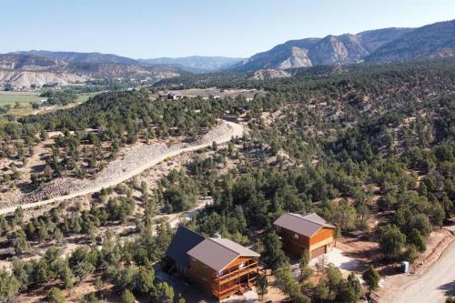 an aerial view of a building with trees and mountains at Cliff's Edge. New Build, Breathtaking Views, Luxury Stay Near Zion in Orderville