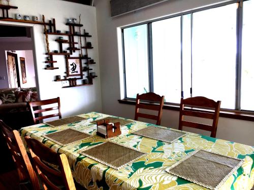 a dining room table with a green and yellow table cloth at GUEST HOUSE IN HILO in Hilo