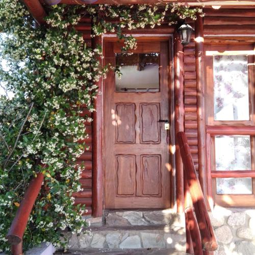 a wooden door on the side of a house at Cabañas Yanasuy in Merlo