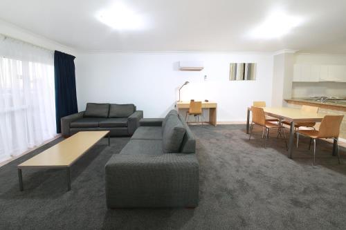 a living room with a couch and a table at Nautica Residences Hillarys in Perth