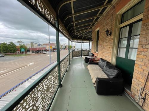 a balcony with couches sitting on the side of a building at Royal Hotel Motel Scone in Scone