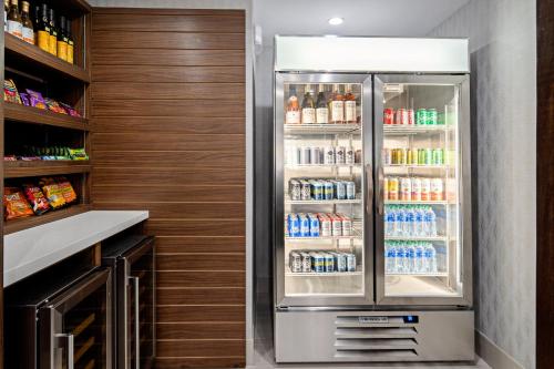a refrigerator filled with lots of drinks in a kitchen at Holiday Inn Express Hotel & Suites Atascadero by IHG in Atascadero