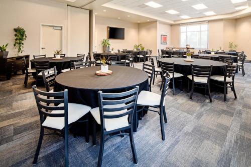 a conference room with tables and chairs and a tv at Holiday Inn Express Hotel & Suites Atascadero by IHG in Atascadero