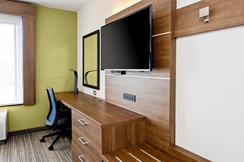 an office with a desk and a tv on a wall at Holiday Inn Express Hotel & Suites Atascadero by IHG in Atascadero