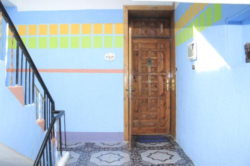 a hallway with a wooden door in a house at Nuba Dool in Aswan