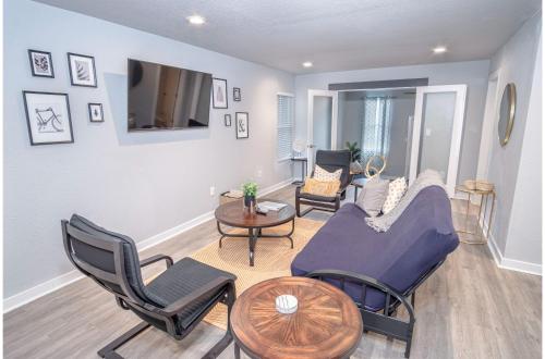 a living room with a couch and chairs and a tv at Stylish 4 Br2Ba Renovated Home Near Downtown in San Antonio