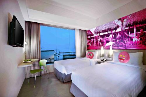 Postel nebo postele na pokoji v ubytování favehotel Cimanuk Garut