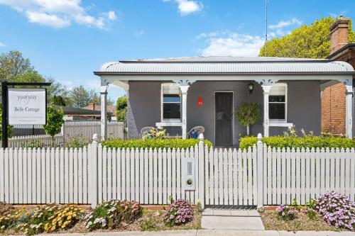 a white picket fence in front of a house at Belle Cottage on March - Central High-End Heritage in Orange
