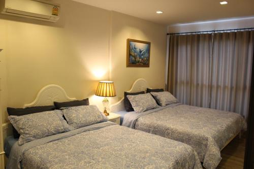 Postel nebo postele na pokoji v ubytování Rain ChaAm-HuaHin JN