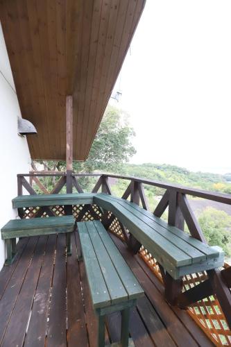 a green bench sitting on top of a wooden deck at 白浜ホープヒルズ　N-33号棟 in Shirahama