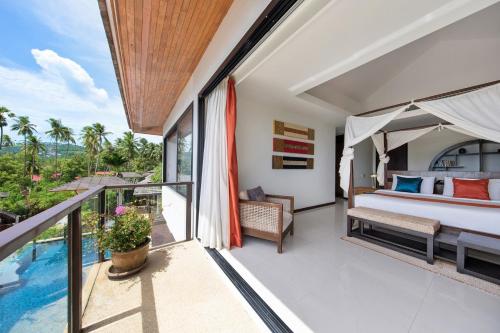 a bedroom with a bed and a balcony with a pool at Dhevatara Residence Sea View Villas in Bophut 