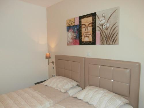 a bedroom with a bed and a picture on the wall at Villa Fun & Sun in Limenaria