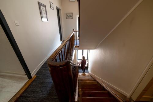 a person walking down a staircase in a building at Logis - Hotel De La Mairie in Embrun