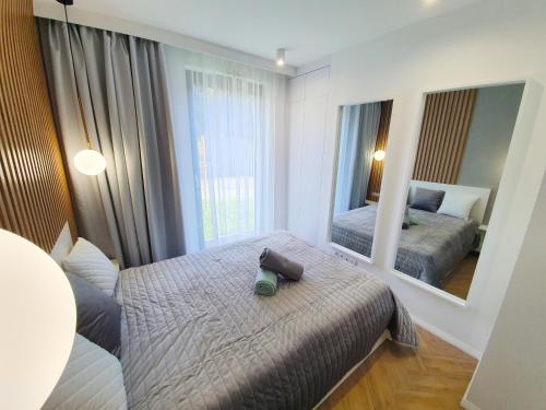 a bedroom with two beds and a large mirror at RelaxApart - Komfortowy apartament Kalinowa in Szczyrk