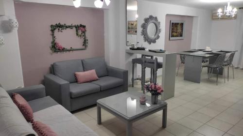 a living room with a couch and a table at Lavender Home in Volos