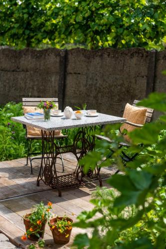 a table and chairs on a patio in a garden at B&B Art.14 in Morkhoven