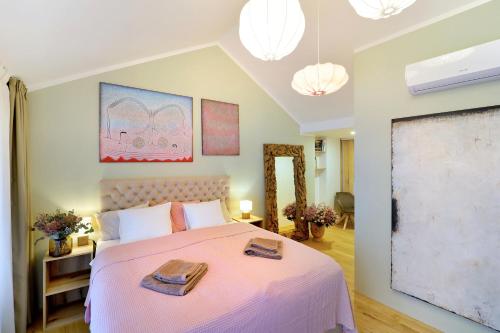 a bedroom with a bed with two towels on it at Kalina Apartments in Brno