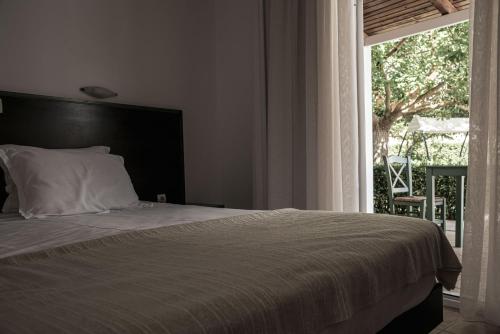 
A bed or beds in a room at Ecoresort Hotel Zefyros
