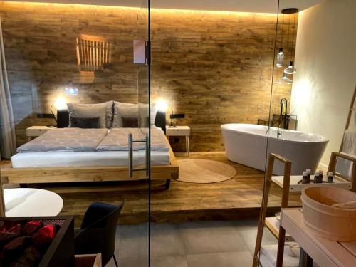 a bedroom with a bed and a bath tub and a tub at Golden Key Apartments in Liberec