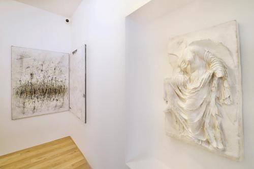 two pieces of art hanging on a wall at Kalina Apartments in Brno