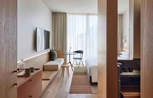 a hotel room with a bed and a table at Hyatt Centric Melbourne in Melbourne