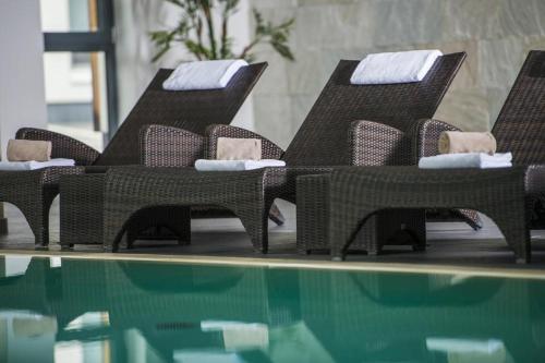 a group of chairs sitting next to a swimming pool at Mountain View Ski Apartment Rauris in Rauris