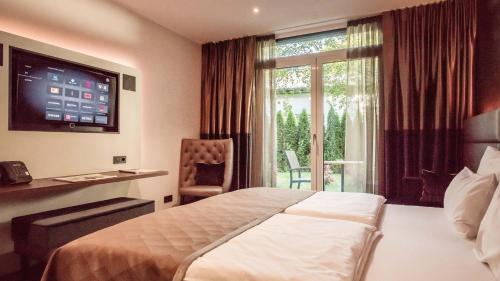a hotel room with a bed and a window at Innspire Hotel in Munich