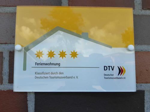 een bord aan de zijkant van een gebouw bij Helgas Ferienwohnung 4 Sterne in Südbrookmerland