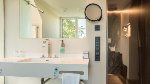 a bathroom with a sink and a mirror at Innspire Hotel in Munich