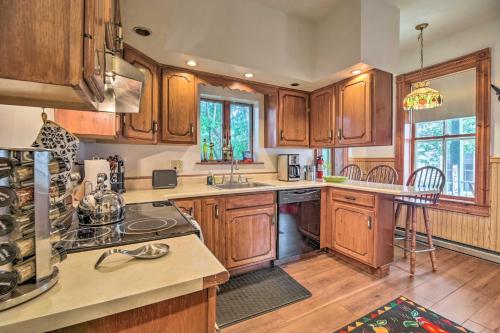 a kitchen with wooden cabinets and a counter top at Historic Apartment - Half Mi to Lake Champlain! in Plattsburgh