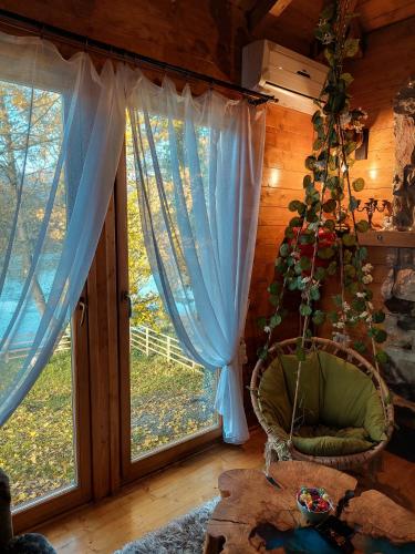 a room with a chair and a large window at Marš na Drinu in Bajina Bašta