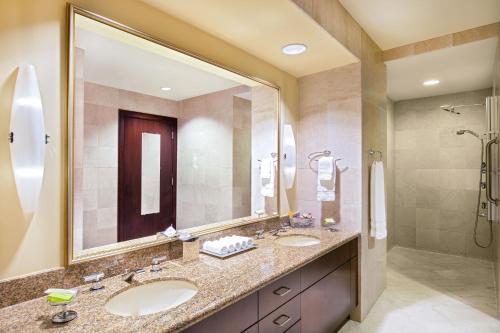 a bathroom with two sinks and a shower at Le Meridien Boston Cambridge in Cambridge