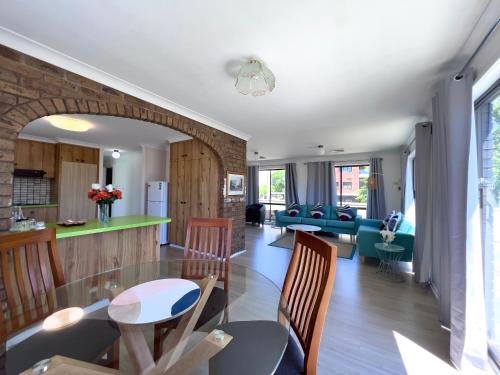 a kitchen and living room with a table and chairs at Albury Garden Court Motel in Albury