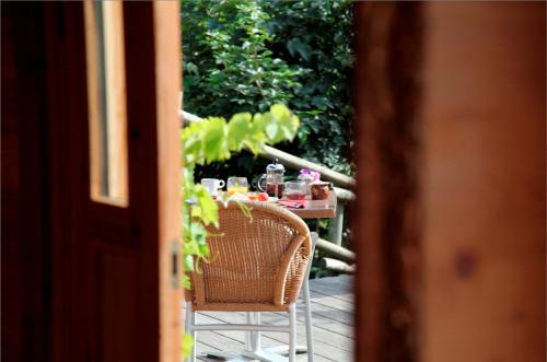 a table with food and drinks on a porch at Hôtel La Ferme du Chozal, Chalet de tradition in Hauteluce