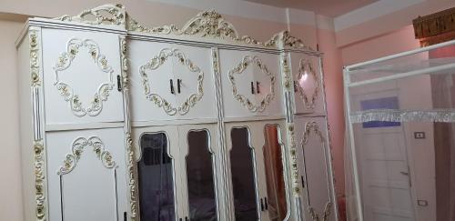a white wardrobe with mirrors in a room at Nuba Dool in Aswan