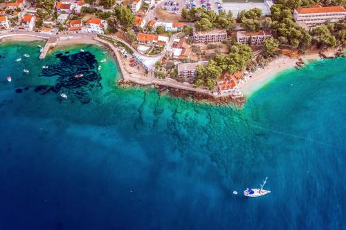 an aerial view of a beach with a boat in the water at Bluesun Holiday Village Bonaca - Full Board Plus in Bol