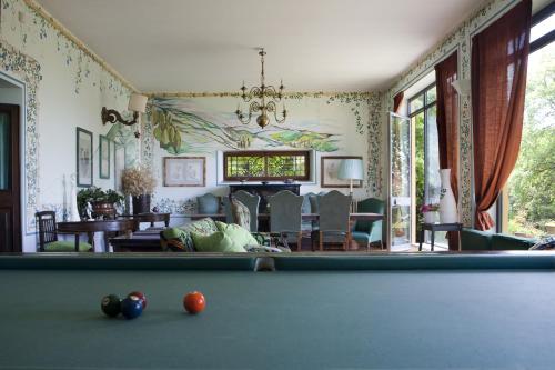 a room with a pool table and a living room at Il Broglino in Todi