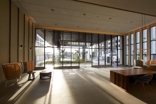 a lobby with a table and chairs in a building at Timurbay by Seascape in Kuantan