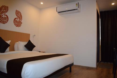 a bedroom with a bed and a air conditioner on the wall at Vishnu Paradise in Mohammadnagar