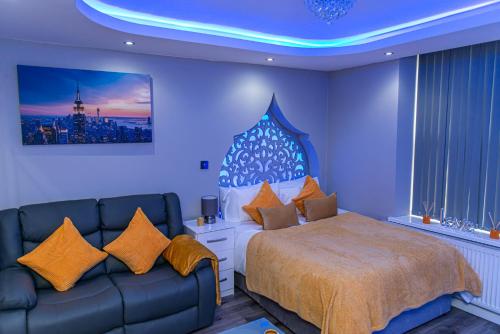a bedroom with a bed and a couch at Meridian Serviced Apartments in Bradford