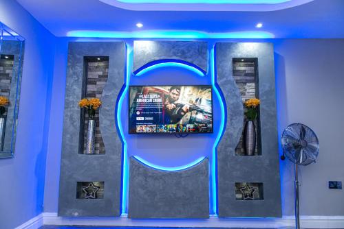 a television exhibit in a room with blue lights at Meridian Serviced Apartments in Bradford