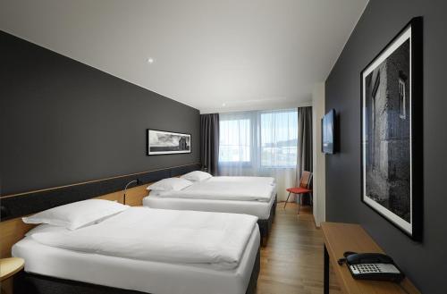 a row of beds in a hotel room at Reykjavik Natura - Berjaya Iceland Hotels in Reykjavík
